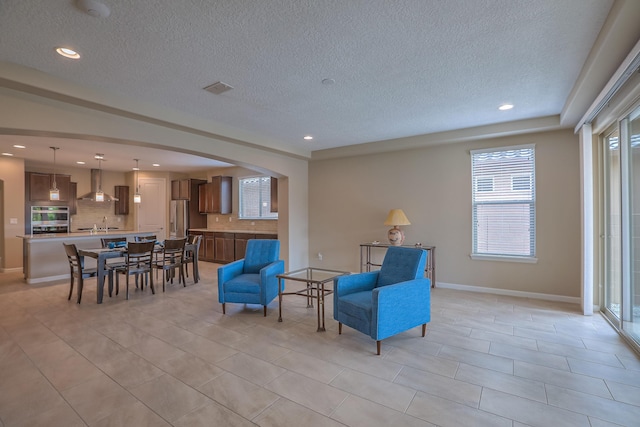 2952 Kings Canyon Loop NE, Rio Rancho, NM 87144 - sitting room with a textured ceiling, recessed lighting, arched walkways, and light tile patterned flooring