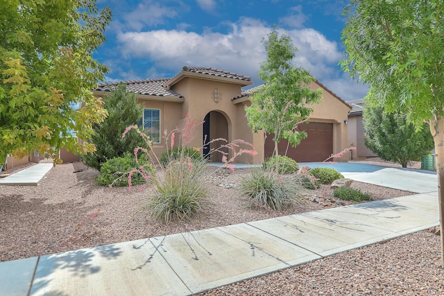2952 Kings Canyon Loop NE, Rio Rancho, NM 87144 - mediterranean / spanish house with a garage, concrete driveway, a tile roof, and stucco siding