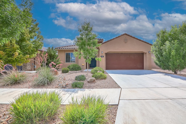 2952 Kings Canyon Loop NE, Rio Rancho, NM 87144 - mediterranean / spanish-style house featuring stucco siding, a garage, concrete driveway, and a tiled roof