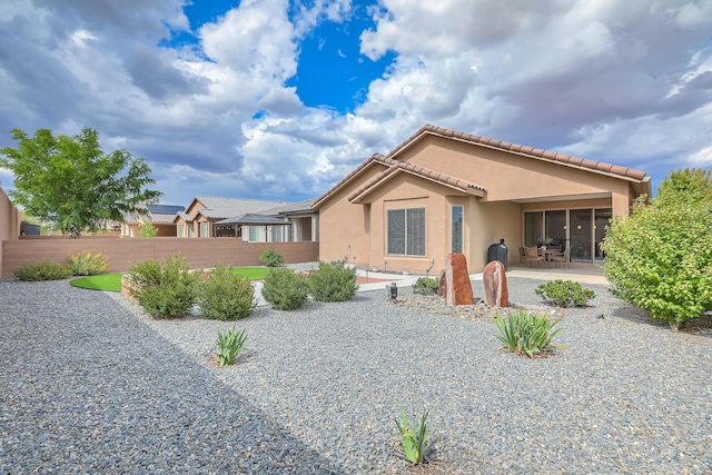 2952 Kings Canyon Loop NE, Rio Rancho, NM 87144 - back of house with stucco siding, a patio, and a tiled roof