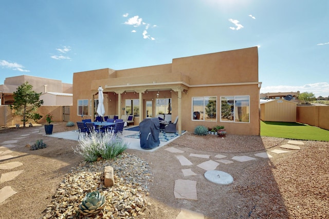 2504 Campeche Rd NE, Rio Rancho, NM 87144 - back of property with stucco siding, a patio, and a fenced backyard