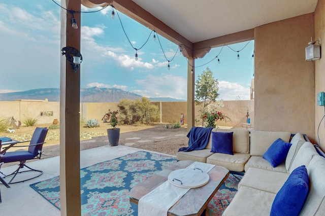 2504 Campeche Rd NE, Rio Rancho, NM 87144 - fenced backyard with an outdoor living space, a patio, and a mountain view