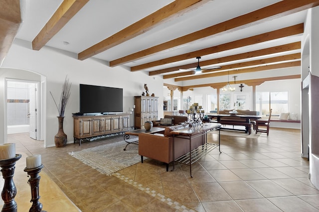 2504 Campeche Rd NE, Rio Rancho, NM 87144 - tiled living room featuring beamed ceiling and arched walkways