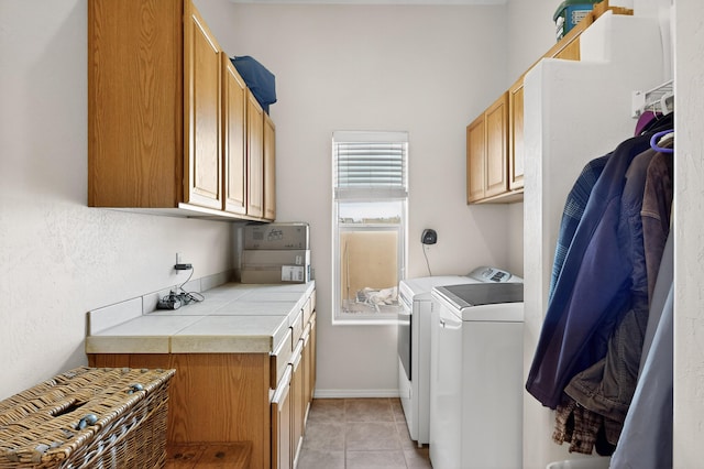 2504 Campeche Rd NE, Rio Rancho, NM 87144 - laundry area featuring independent washer and dryer, cabinet space, and light tile patterned floors