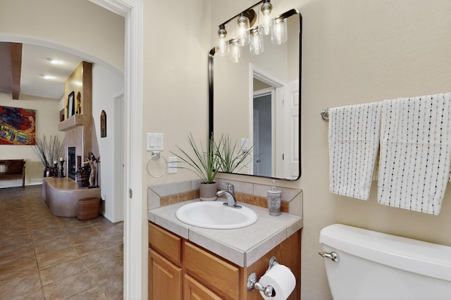 2504 Campeche Rd NE, Rio Rancho, NM 87144 - half bathroom featuring vanity and a fireplace
