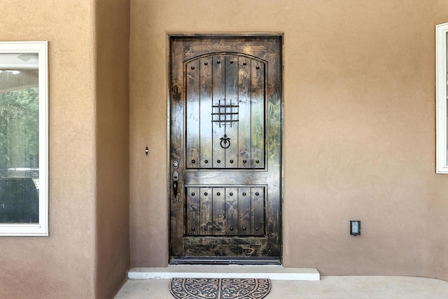 76 Otero Rd, Los Lunas, NM 87031 - view of exterior entry with stucco siding