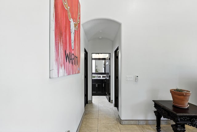 76 Otero Rd, Los Lunas, NM 87031 - corridor featuring light tile patterned floors and arched walkways