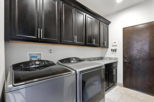76 Otero Rd, Los Lunas, NM 87031 - laundry area with washer and clothes dryer, cabinet space, and light tile patterned floors