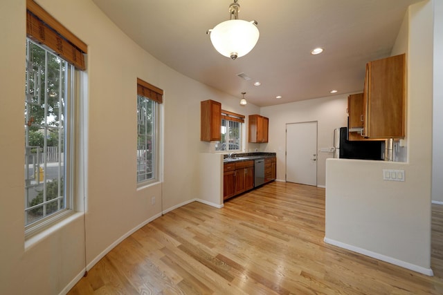 315 11th St SW, Albuquerque, NM 87102 - kitchen with stainless steel dishwasher, light wood finished floors, brown cabinetry, recessed lighting, and freestanding refrigerator