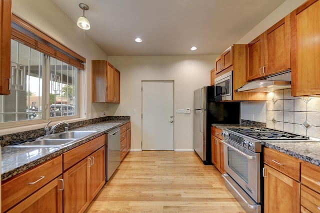 315 11th St SW, Albuquerque, NM 87102 - kitchen featuring appliances with stainless steel finishes, light wood-style floors, under cabinet range hood, brown cabinetry, and recessed lighting