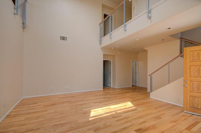 315 11th St SW, Albuquerque, NM 87102 - empty room featuring stairway, a towering ceiling, and wood finished floors