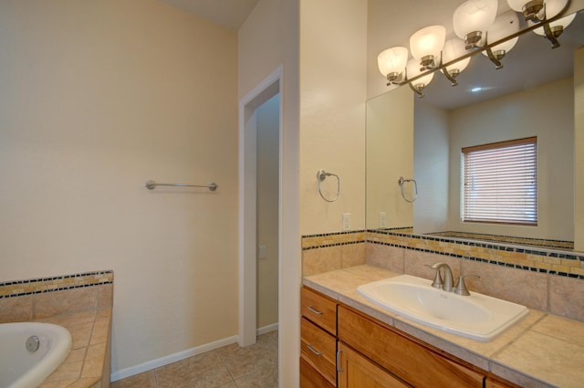 315 11th St SW, Albuquerque, NM 87102 - bathroom with vanity, tiled tub, tile patterned flooring, a chandelier, and decorative backsplash