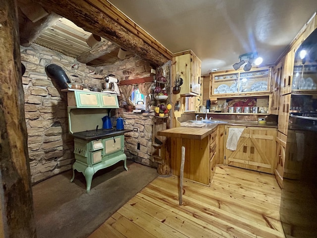 indoor bar with light wood-style floors and fridge