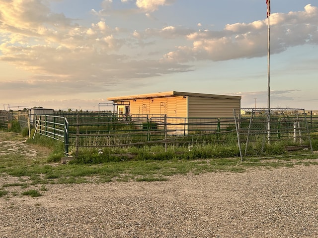 view of outbuilding featuring an exterior structure and a view of rural / pastoral area