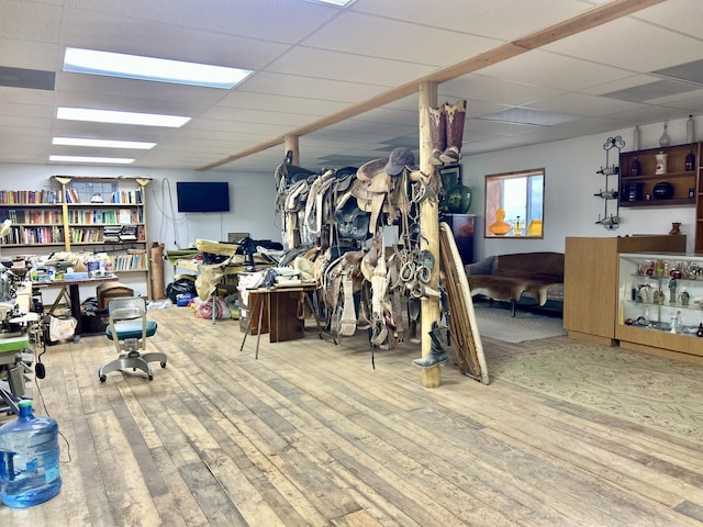 interior space with hardwood / wood-style floors and a drop ceiling