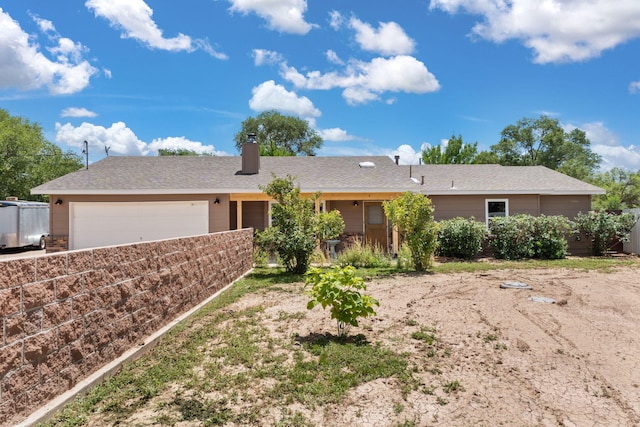 36 Palomas Rd, Los Lunas, NM 87031 - ranch-style house featuring an attached garage, a chimney, and concrete driveway