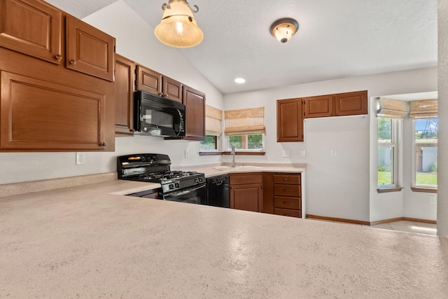 36 Palomas Rd, Los Lunas, NM 87031 - kitchen with black appliances, light countertops, and brown cabinetry