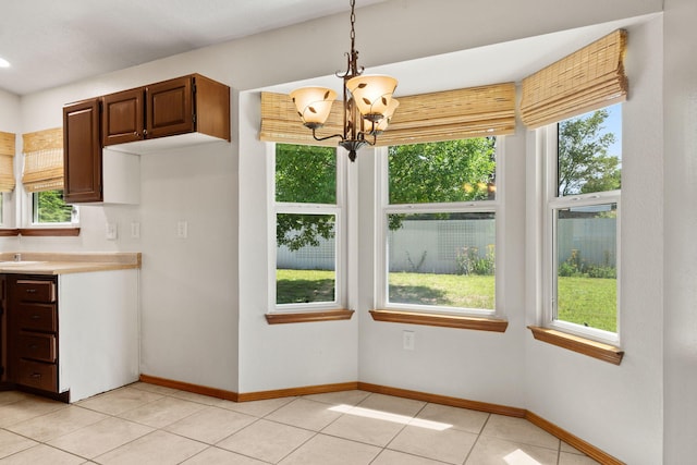 36 Palomas Rd, Los Lunas, NM 87031 - unfurnished dining area featuring a chandelier and light tile patterned floors