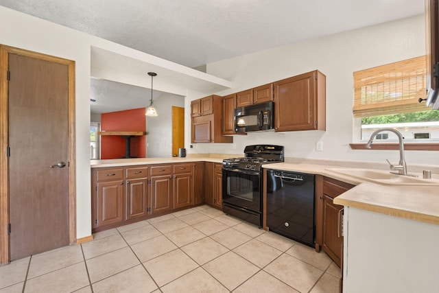 36 Palomas Rd, Los Lunas, NM 87031 - kitchen with black appliances, light tile patterned flooring, light countertops, hanging light fixtures, and brown cabinetry