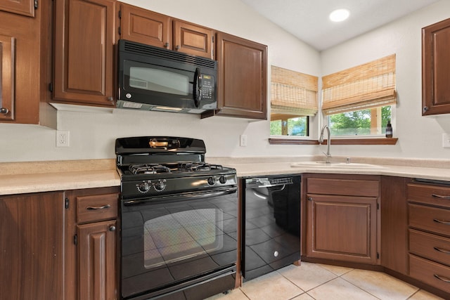 36 Palomas Rd, Los Lunas, NM 87031 - kitchen featuring black appliances, light countertops, vaulted ceiling, light tile patterned flooring, and recessed lighting