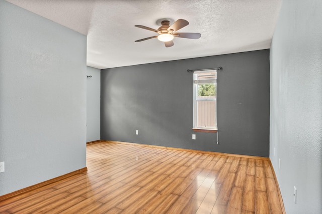 36 Palomas Rd, Los Lunas, NM 87031 - empty room featuring ceiling fan, wood finished floors, and a textured ceiling
