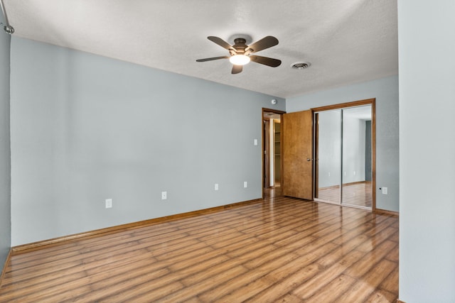 36 Palomas Rd, Los Lunas, NM 87031 - unfurnished bedroom featuring light wood-style floors, a closet, a textured ceiling, and a ceiling fan