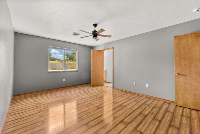 36 Palomas Rd, Los Lunas, NM 87031 - unfurnished bedroom featuring wood finished floors, a textured ceiling, and ceiling fan