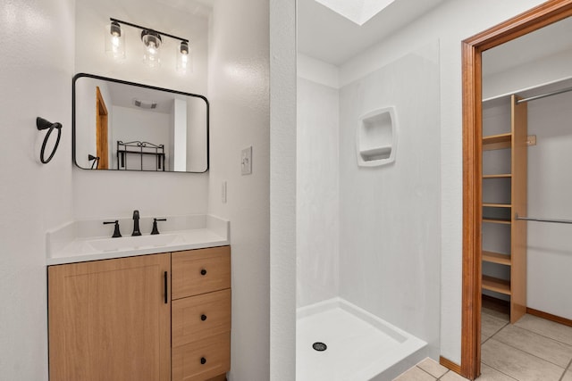 36 Palomas Rd, Los Lunas, NM 87031 - bathroom featuring vanity, a shower stall, tile patterned flooring, and a spacious closet