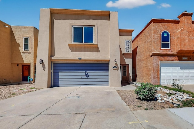 5415 Colleens Way NE, Albuquerque, NM 87111 - view of front of home with a garage, driveway, and stucco siding