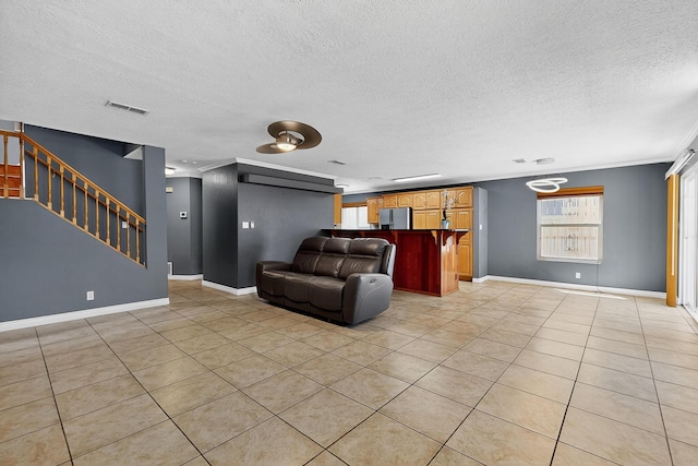 5415 Colleens Way NE, Albuquerque, NM 87111 - living room with light tile patterned floors, a textured ceiling, and stairs