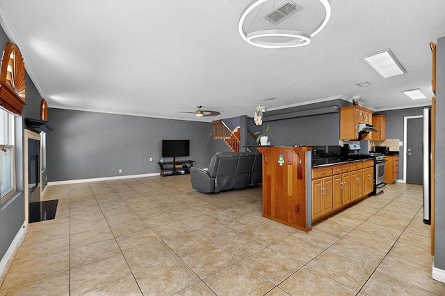 5415 Colleens Way NE, Albuquerque, NM 87111 - kitchen featuring stainless steel range with gas cooktop, crown molding, dark countertops, light tile patterned floors, and ceiling fan