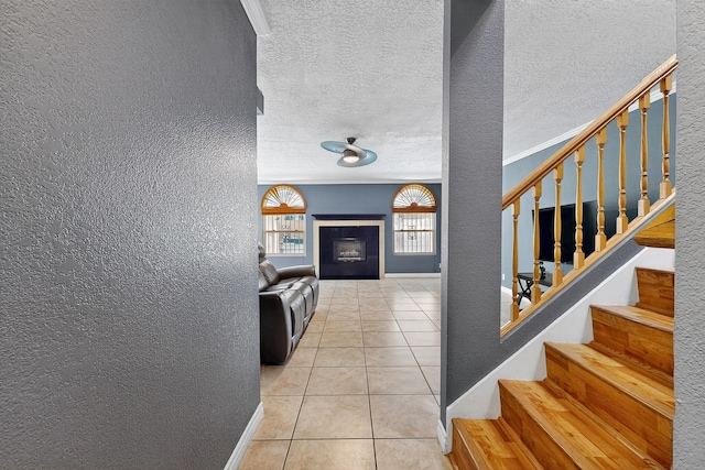 5415 Colleens Way NE, Albuquerque, NM 87111 - tiled entrance foyer with a textured wall, stairs, and a textured ceiling