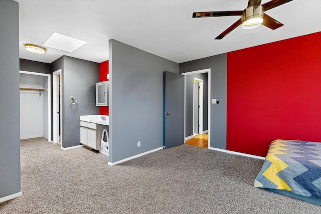 5415 Colleens Way NE, Albuquerque, NM 87111 - carpeted bedroom featuring a skylight, ceiling fan, and a closet