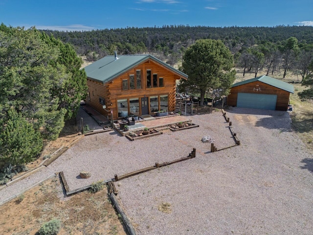 195 Ferguson Rd, Ramah, NM 87321 - log cabin featuring a wooded view, a detached garage, log siding, and an outdoor structure