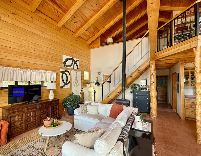 195 Ferguson Rd, Ramah, NM 87321 - living area with high vaulted ceiling, wooden walls, a wooden ceiling with exposed beams, stairway, and tile patterned floors