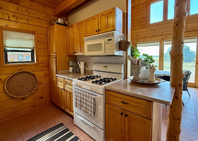 195 Ferguson Rd, Ramah, NM 87321 - kitchen with white appliances, wood walls, light tile patterned floors, light countertops, and beamed ceiling