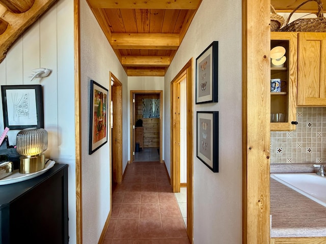 195 Ferguson Rd, Ramah, NM 87321 - corridor featuring a wooden ceiling with exposed beams, tile patterned floors, and a textured wall