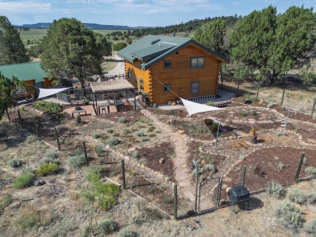 195 Ferguson Rd, Ramah, NM 87321 - back of property featuring log siding and a gate