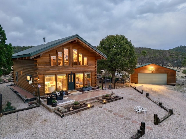 195 Ferguson Rd, Ramah, NM 87321 - back of house with log exterior, a detached garage, and an outdoor structure