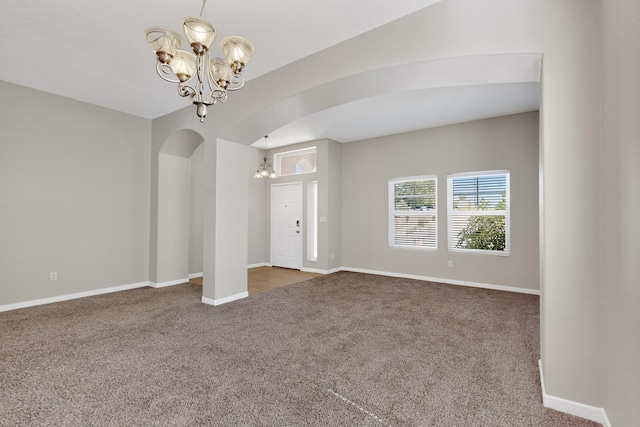 2048 N Ensenada Cir SE, Rio Rancho, NM 87124 - entrance foyer featuring a chandelier, carpet floors, and arched walkways