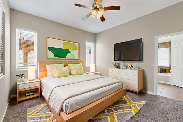 2048 N Ensenada Cir SE, Rio Rancho, NM 87124 - carpeted bedroom with multiple windows, ensuite bath, and ceiling fan