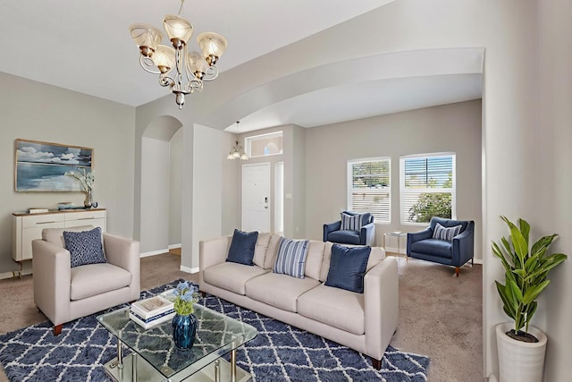 2048 N Ensenada Cir SE, Rio Rancho, NM 87124 - living room featuring a chandelier, carpet flooring, and arched walkways