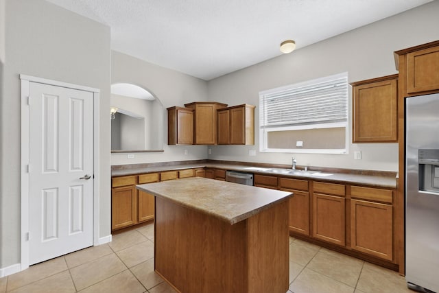 2048 N Ensenada Cir SE, Rio Rancho, NM 87124 - kitchen featuring stainless steel appliances, a center island, brown cabinets, and light tile patterned flooring