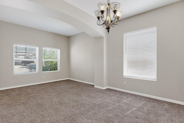2048 N Ensenada Cir SE, Rio Rancho, NM 87124 - carpeted empty room featuring a chandelier and arched walkways