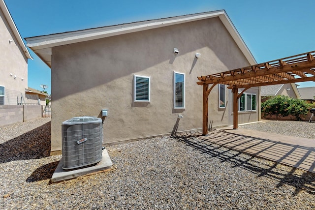 2048 N Ensenada Cir SE, Rio Rancho, NM 87124 - back of house with a pergola, stucco siding, and a patio area
