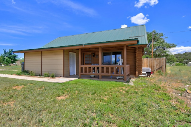58 Quiet Valley Loop, Edgewood, NM 87015 - view of front of property featuring a metal roof, log exterior, and a patio area