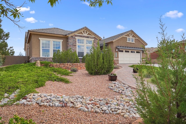 2308 Desert View Rd NE, Rio Rancho, NM 87144 - view of front facade featuring stucco siding, stone siding, a tile roof, an attached garage, and driveway