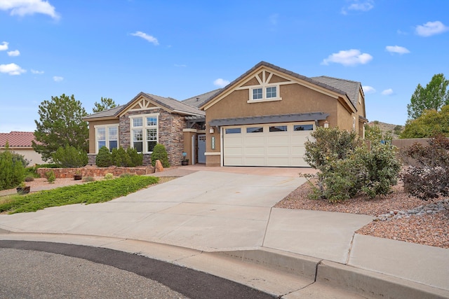 2308 Desert View Rd NE, Rio Rancho, NM 87144 - view of front of house with stucco siding, stone siding, concrete driveway, and a tile roof