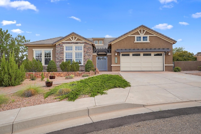 2308 Desert View Rd NE, Rio Rancho, NM 87144 - view of front of house with stucco siding, stone siding, concrete driveway, a tile roof, and an attached garage