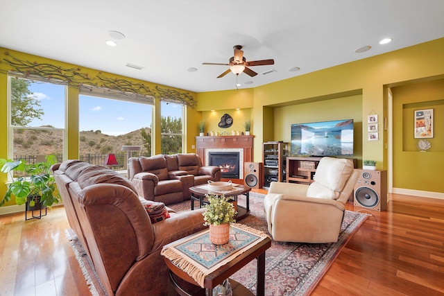 2308 Desert View Rd NE, Rio Rancho, NM 87144 - living room with a ceiling fan, a glass covered fireplace, wood-type flooring, and recessed lighting